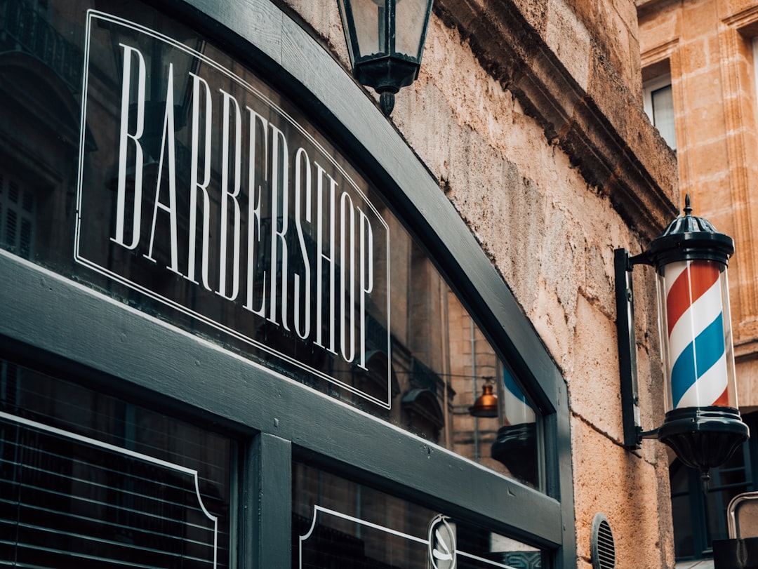 a man getting his hair cut by a barber