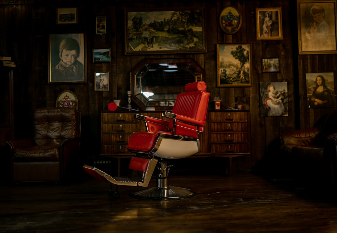 a barber shop with two men standing in front of it