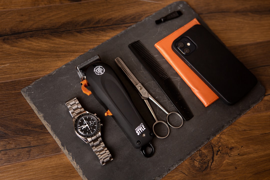 orange book beside black and white round container on brown wooden table